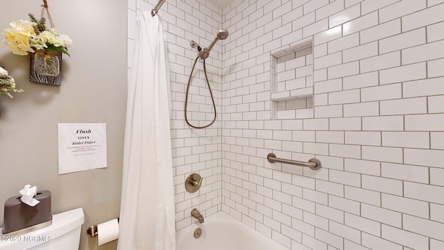 bathroom with shower / tub combo and toilet