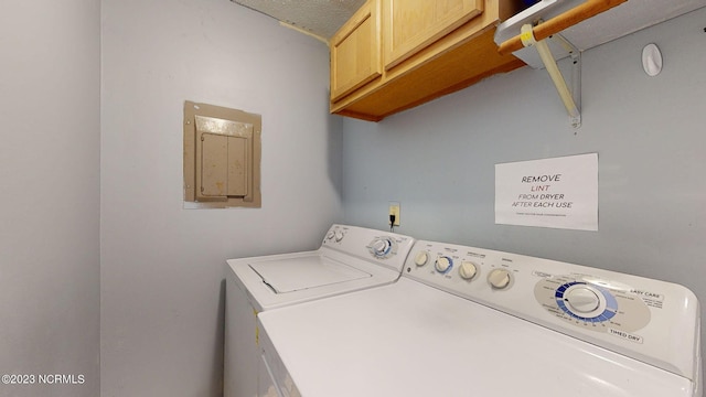 washroom featuring cabinets and independent washer and dryer