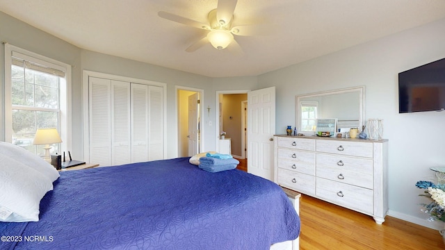 bedroom featuring ceiling fan, light hardwood / wood-style floors, and a closet