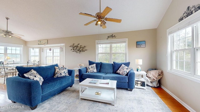 living room featuring vaulted ceiling, hardwood / wood-style floors, and ceiling fan