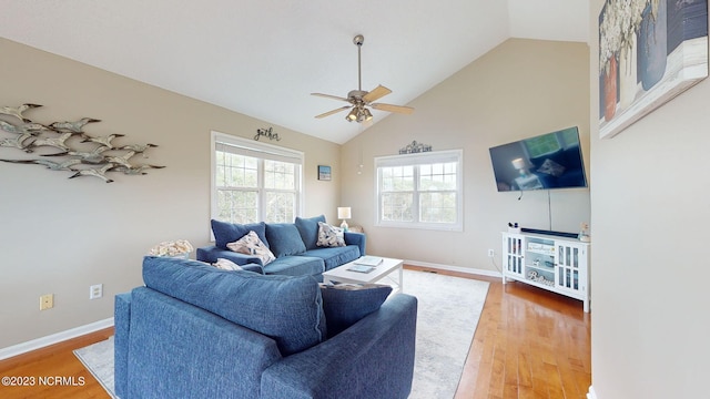 living room featuring wood-type flooring, high vaulted ceiling, and ceiling fan