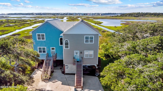 view of front of property with a water view and a carport