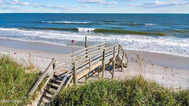 surrounding community with a water view and a view of the beach