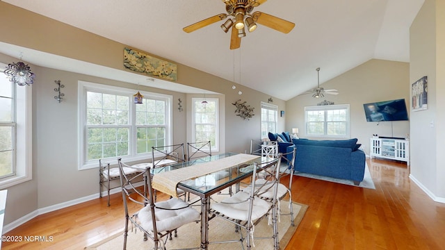 dining space featuring lofted ceiling, hardwood / wood-style flooring, and ceiling fan