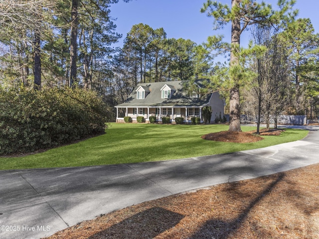 cape cod-style house featuring a front lawn and a porch