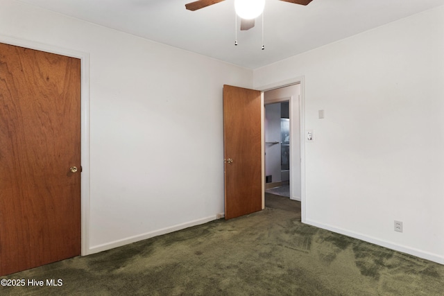 unfurnished room featuring ceiling fan and dark colored carpet