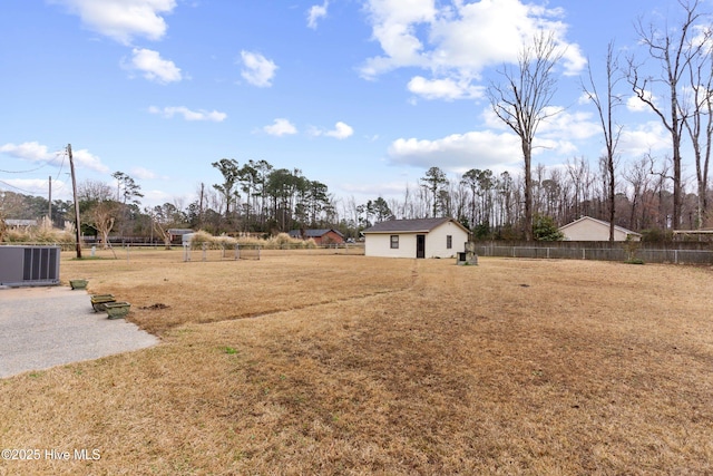 view of yard featuring an outdoor structure and central AC