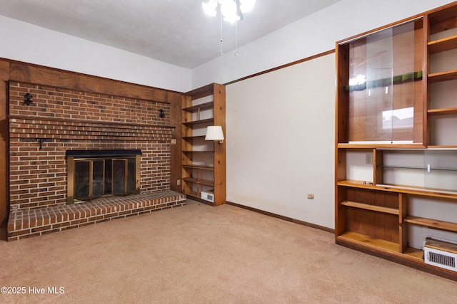 unfurnished living room with light colored carpet and a brick fireplace