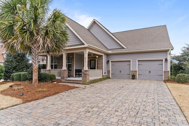 craftsman-style house with a garage and covered porch