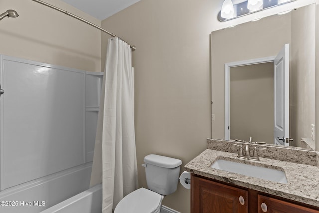 full bathroom with vanity, shower / tub combo, and toilet