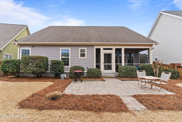 rear view of house featuring a sunroom and a patio area