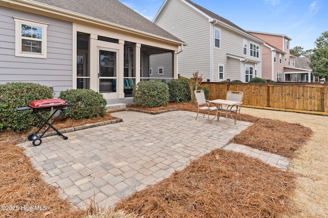 rear view of property with a patio and a sunroom