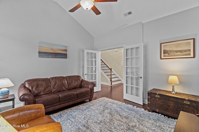 living room featuring vaulted ceiling, dark wood-type flooring, ceiling fan, and french doors