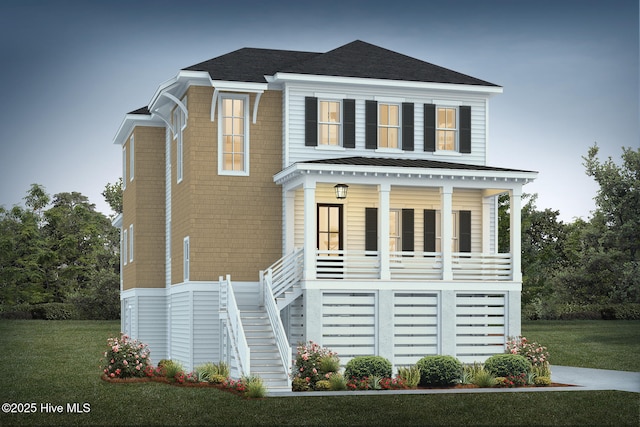 view of front facade featuring metal roof, covered porch, stairs, roof with shingles, and a front yard