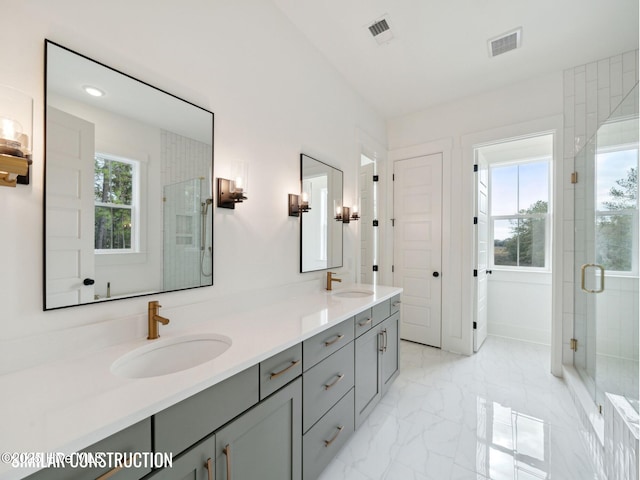 full bath featuring marble finish floor, a sink, and visible vents