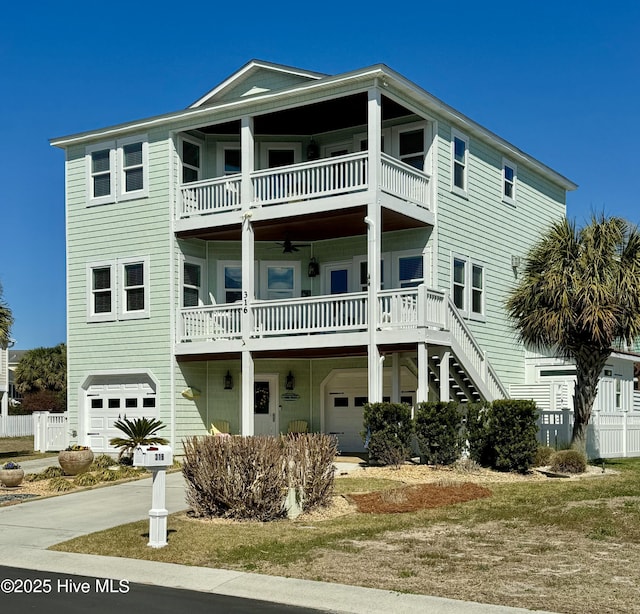 view of front of home featuring a garage, stairway, and a balcony