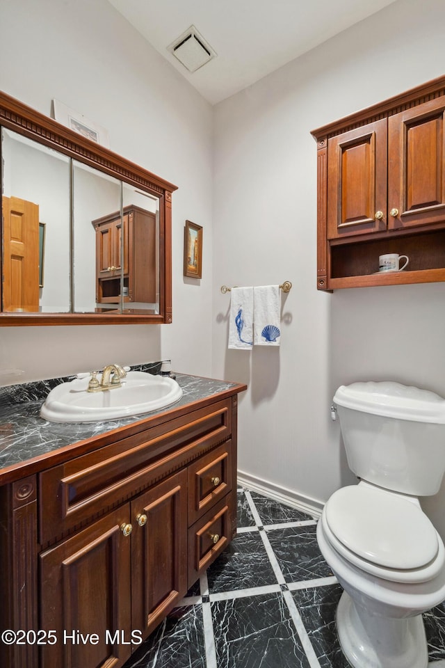 bathroom featuring vanity and toilet