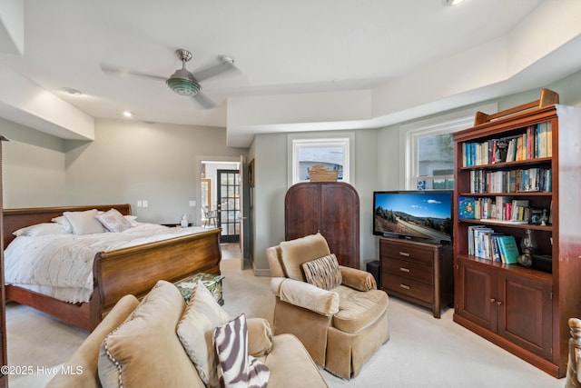 carpeted bedroom with multiple windows and ceiling fan