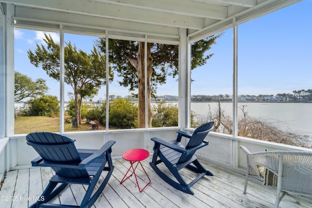 sunroom / solarium featuring a water view