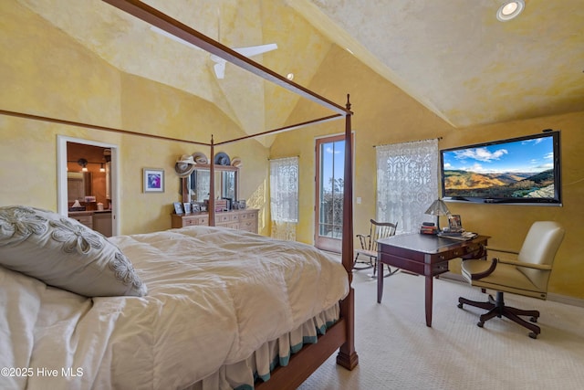 carpeted bedroom with ensuite bath, high vaulted ceiling, and access to outside