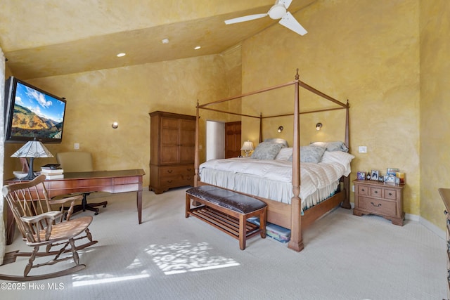 carpeted bedroom with high vaulted ceiling