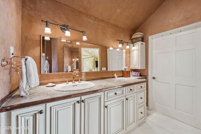 bathroom with vanity and vaulted ceiling