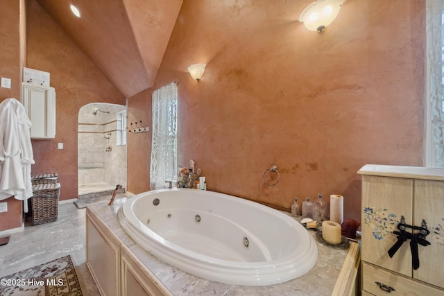 bathroom featuring a bathing tub and vaulted ceiling