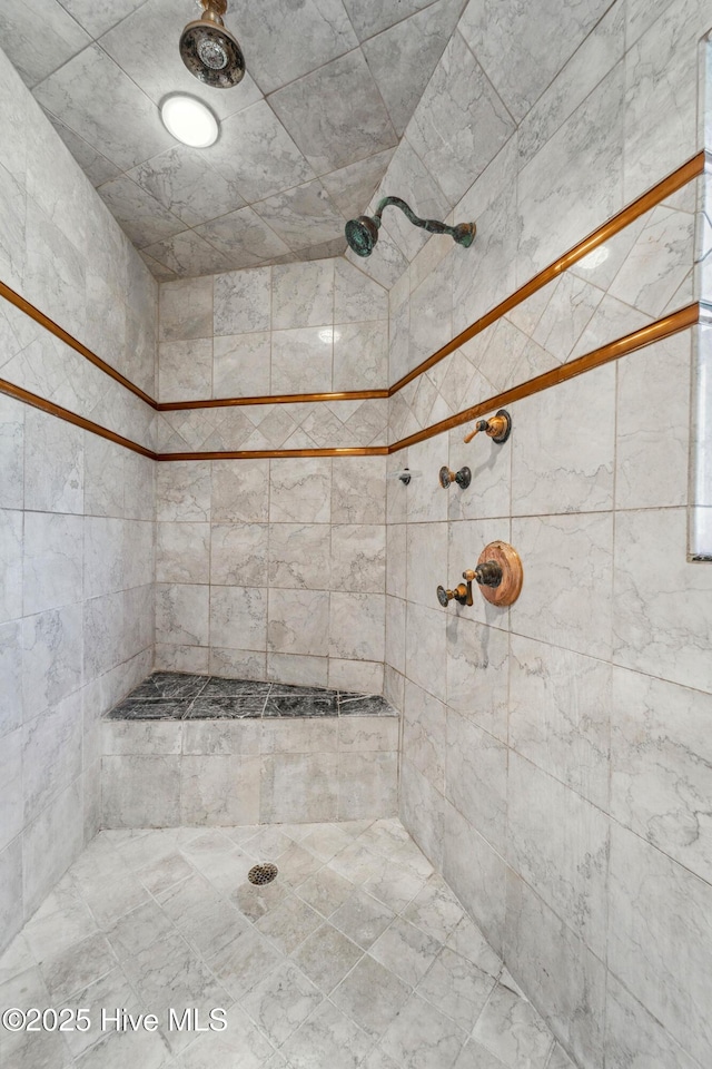 bathroom with a tile shower