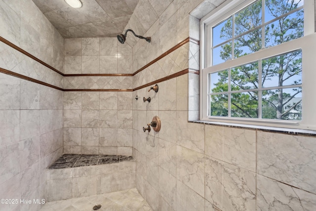 bathroom with a tile shower