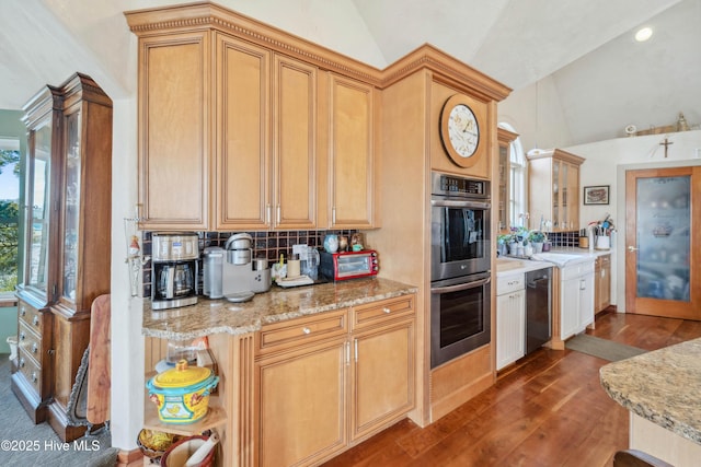 kitchen featuring lofted ceiling, decorative backsplash, stainless steel appliances, and hardwood / wood-style flooring