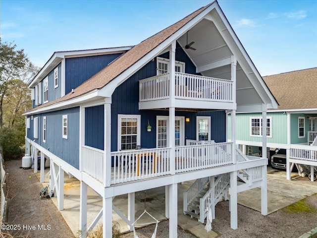 back of house with ceiling fan and covered porch