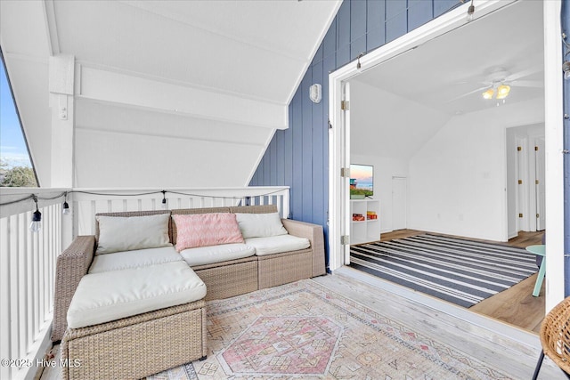 living room featuring lofted ceiling, ceiling fan, and light wood-type flooring