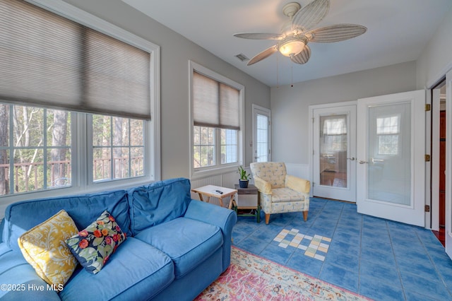 tiled living room featuring ceiling fan