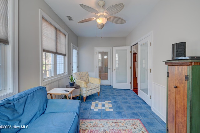 sitting room with french doors and ceiling fan