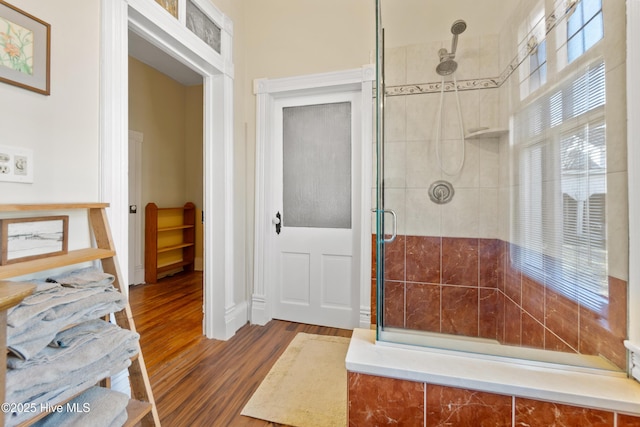 bathroom with wood-type flooring and an enclosed shower