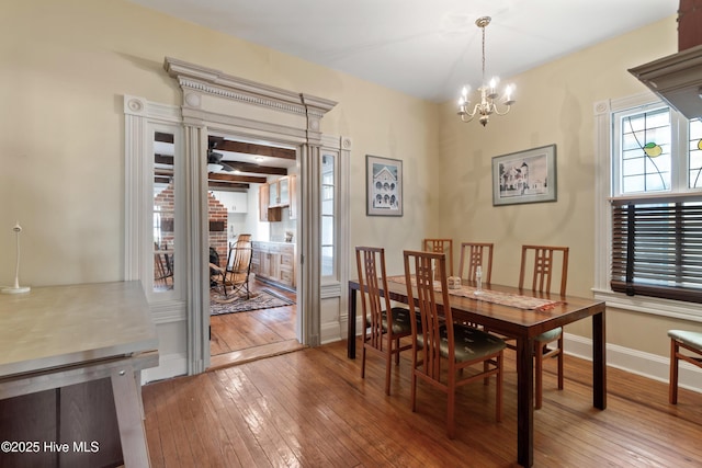 dining area with hardwood / wood-style flooring and a notable chandelier