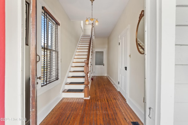 foyer featuring a notable chandelier and dark hardwood / wood-style floors