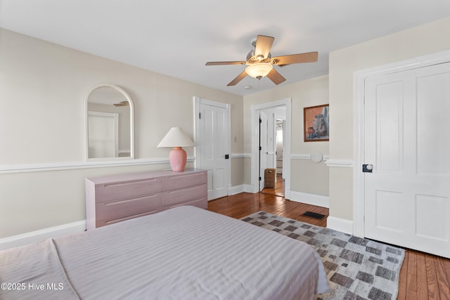 bedroom with dark wood-type flooring and ceiling fan