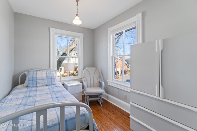 bedroom featuring dark wood-type flooring and white refrigerator