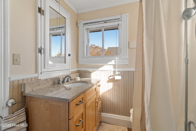 bathroom with vanity, crown molding, and wood walls