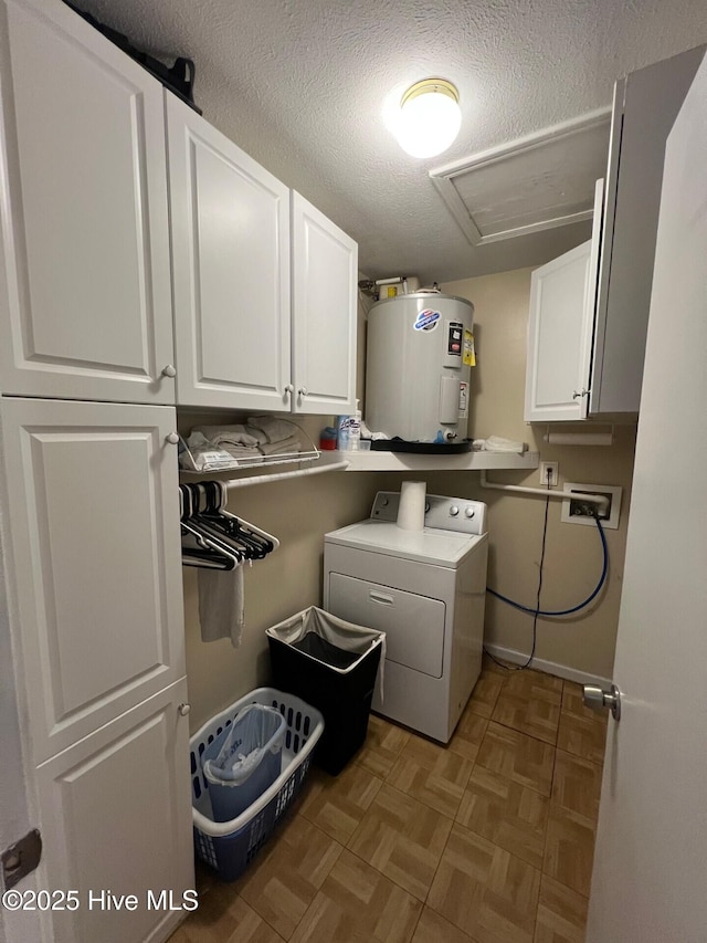 clothes washing area with water heater, washer / dryer, light parquet floors, cabinets, and a textured ceiling