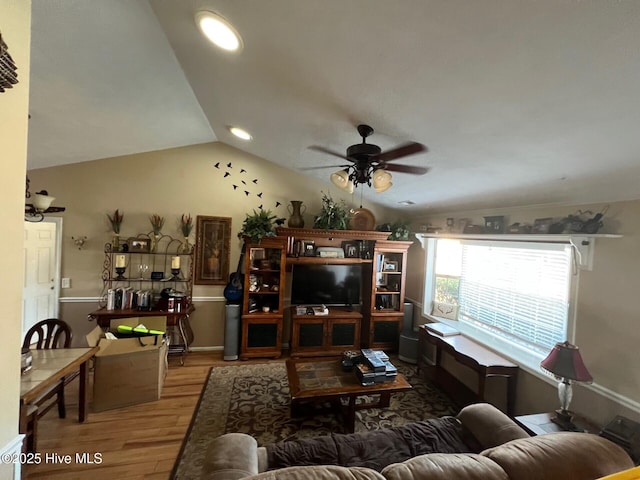 living room featuring lofted ceiling, hardwood / wood-style floors, and ceiling fan