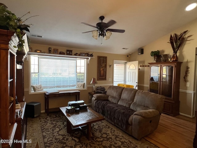 living room featuring lofted ceiling, hardwood / wood-style flooring, and ceiling fan