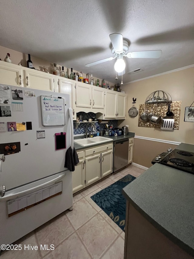 kitchen featuring sink, a textured ceiling, dishwasher, white fridge, and ceiling fan