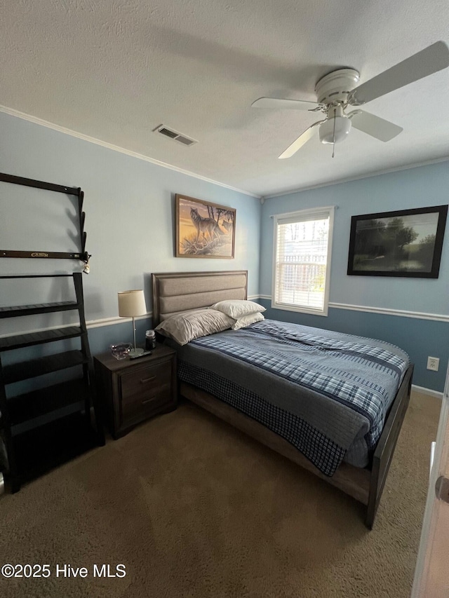 carpeted bedroom with crown molding, ceiling fan, and a textured ceiling