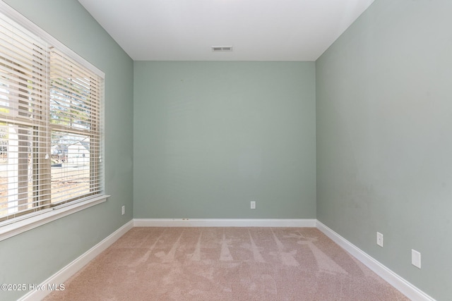 empty room featuring light colored carpet