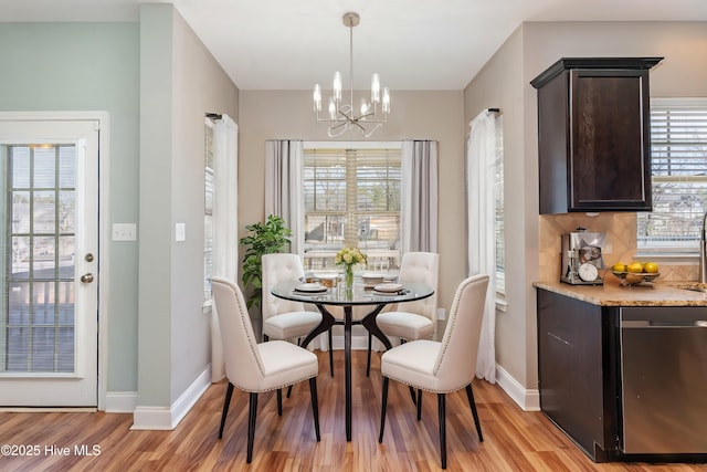 dining room featuring an inviting chandelier and light hardwood / wood-style flooring