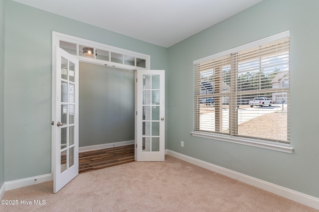 carpeted empty room with french doors