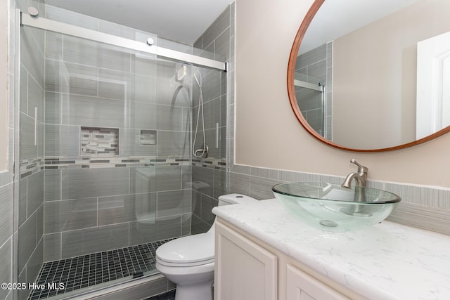 bathroom with vanity, an enclosed shower, and toilet