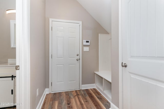 mudroom with dark hardwood / wood-style flooring and vaulted ceiling